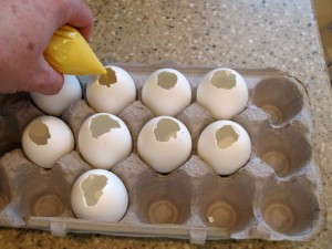 Filling egg shells with melted chocolate